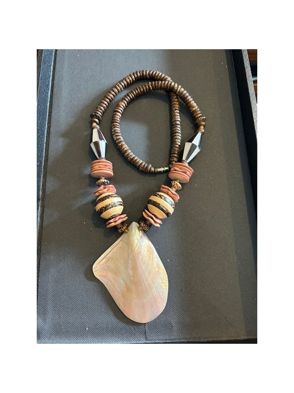 Gorgeous wood and mother of pearl beads, featuring a beautiful shell pendant